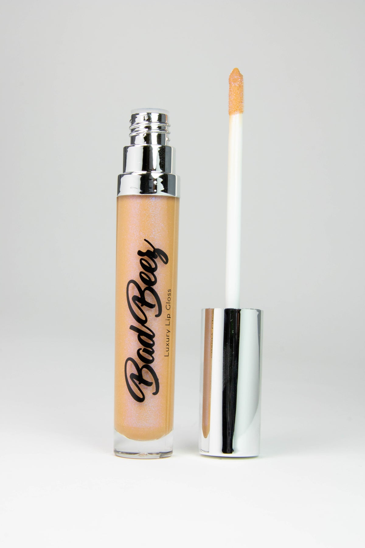 sandy , caramel toned shimmer lip gloss in a tube